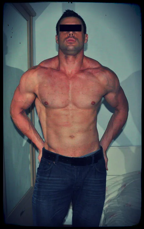 A lean, muscular man flexing shirtless