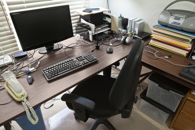 What not to do - cluttered desk, facing a wall, back to an open door. This is not the power position, this is the powerless position and will cause anxiety. Your back should be to the wall so you can see everything going on in the room.